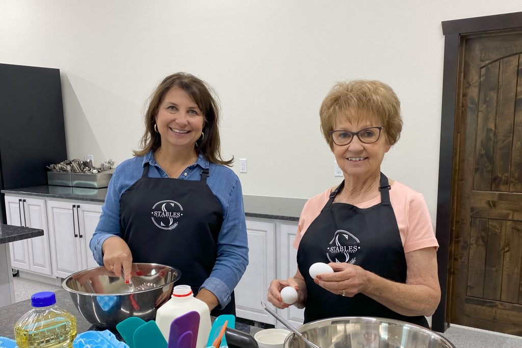 two women taking a cooking class