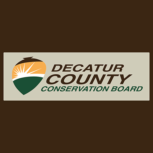 Logo of Decatur County Conservation Board featuring a stylized acorn shape with a sunburst and green landscape, alongside the text "Decatur County Conservation Board" on a brown background.